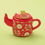 tea pot red with white flower